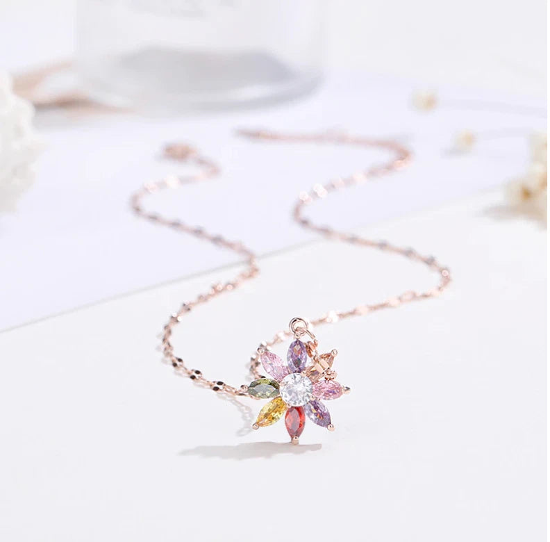 Dainty flower charm necklace with rose-gold tone chain and crystal pendant
