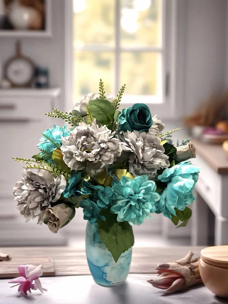 Turquoise floral arrangement centerpiece in clear glass vase with gray and teal blooms