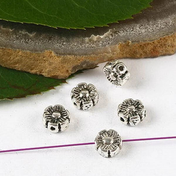 Tibetan silver sunflower spacer beads with embossed flower design and center holes