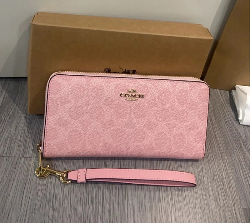 Long zip-around wallet in pink canvas with gold-tone logo and wrist strap