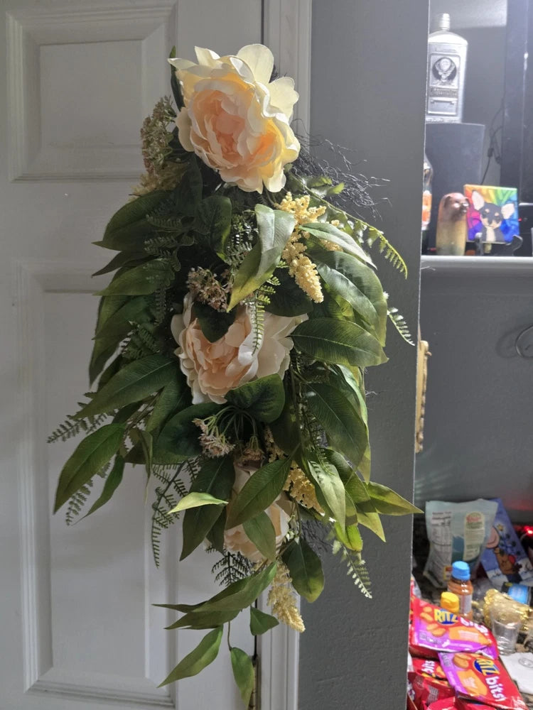 Autumn floral wall swag wreath with peach and cream flowers and green leaves
