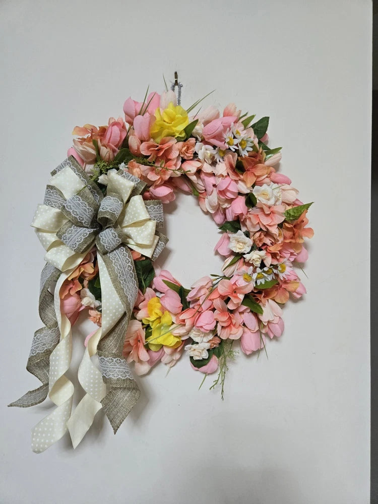 Tulip front door wreath with pink, peach, and yellow flowers and a striped fabric bow