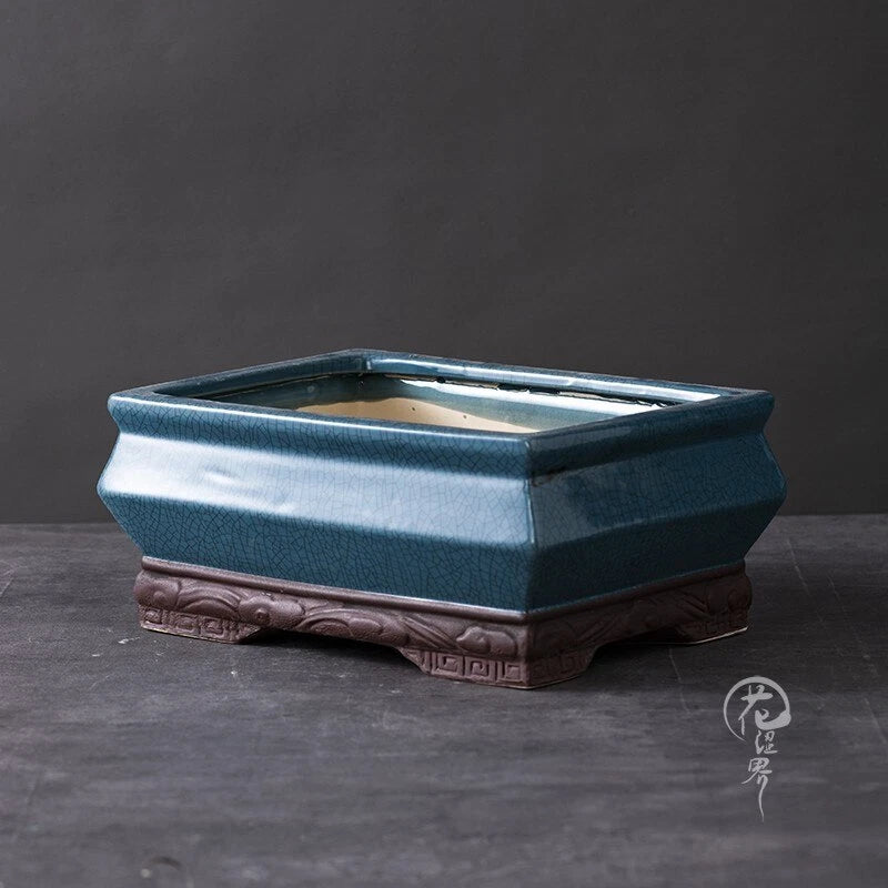 Teal glazed ceramic rectangle bonsai pot with carved base and open center
