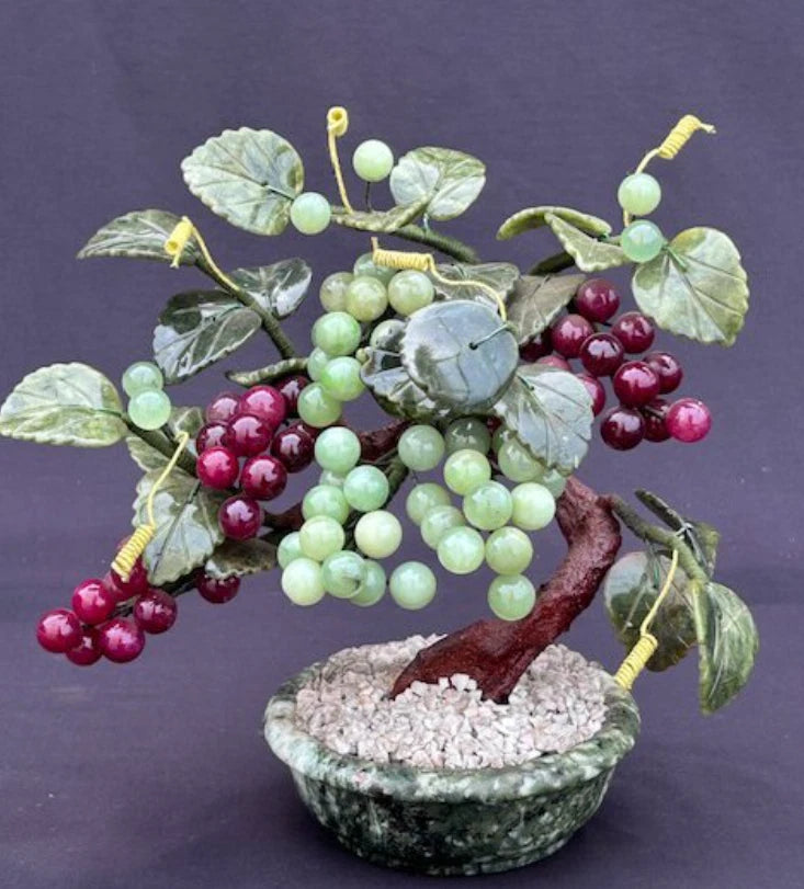 Artificial grape tree bonsai in green ceramic pot, clusters of green and red grapes