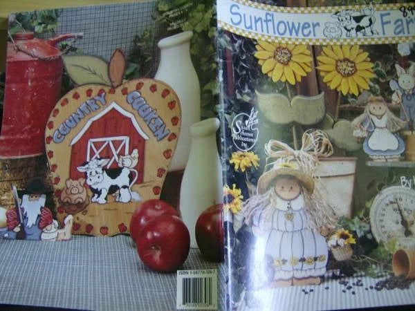 Sunflower farm painting book with illustrated cabin, sunflowers, and a seated farm girl