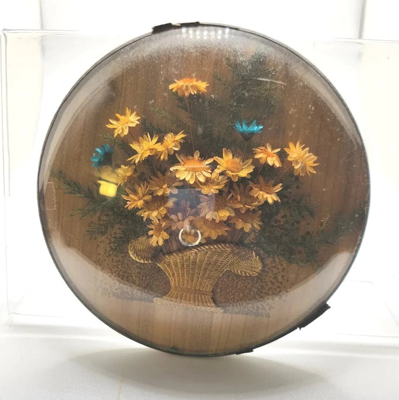Dried flower arrangement under convex bubble glass dome with yellow blooms and blue accents