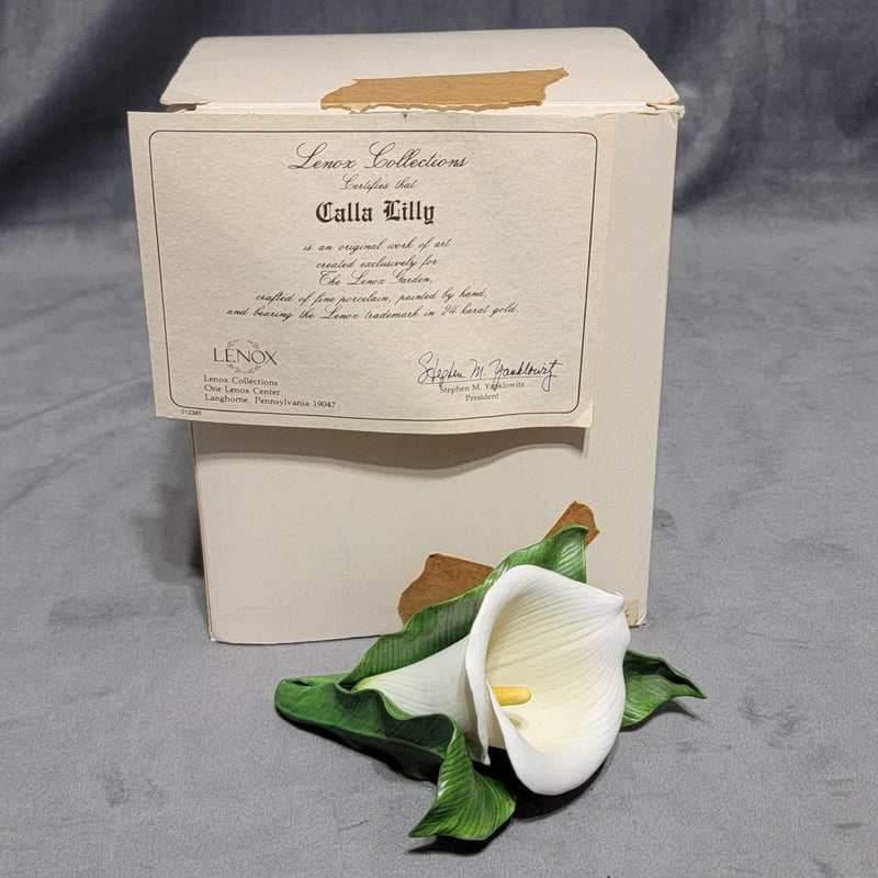 Calla lily decorative figurine with white gift box and certificate card; green leaves