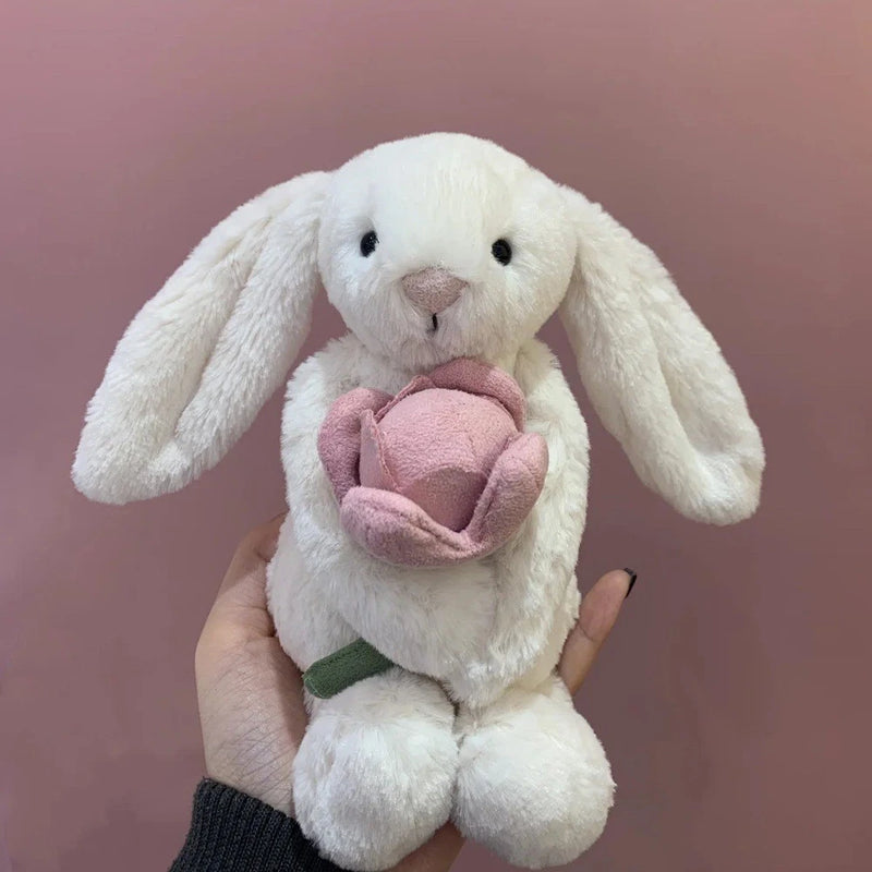 Small white plush rabbit holding pink peony flower, cuddly gift doll, 18 cm