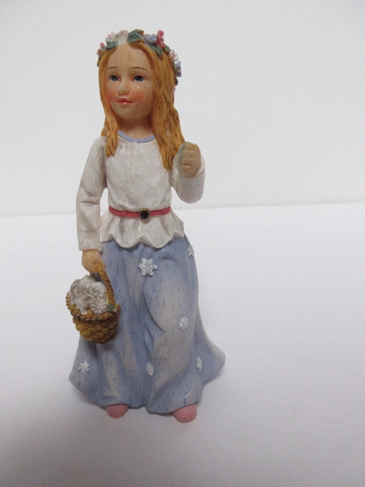 Angel figurine in blue skirt holding flower bouquet, floral crown