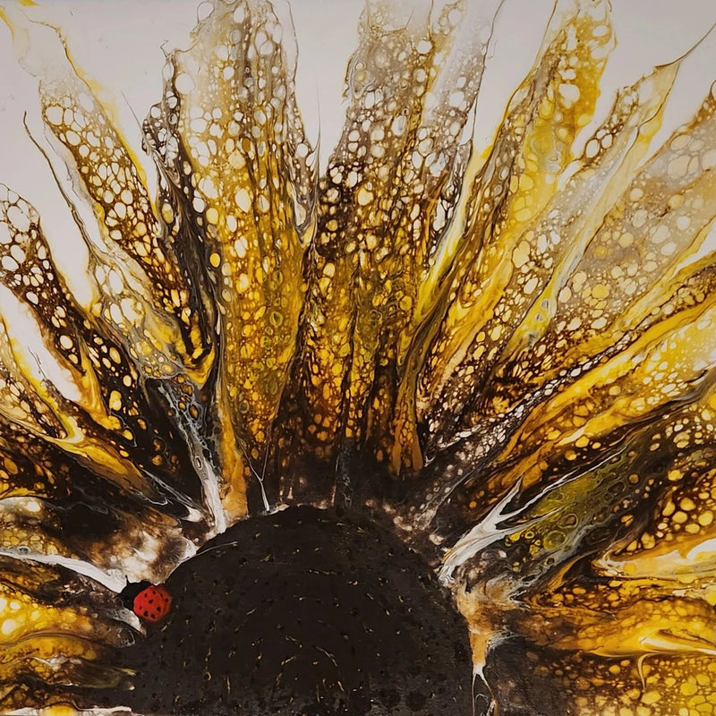 Acrylic pour canvas painting with golden-yellow sunflower petals and dark center with speckles
