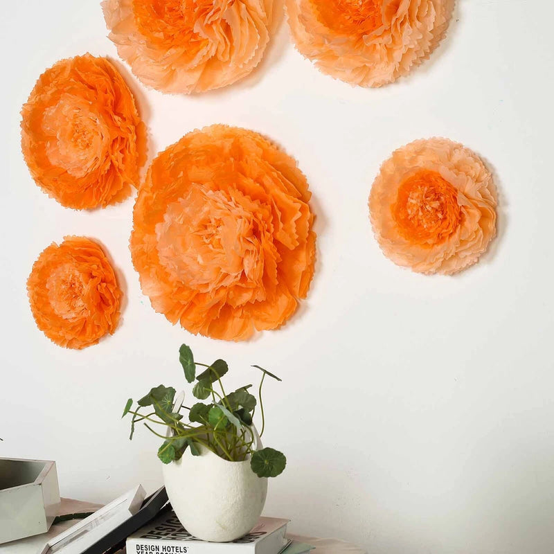 Coral and orange tissue paper carnation flowers with green stems in a white vase