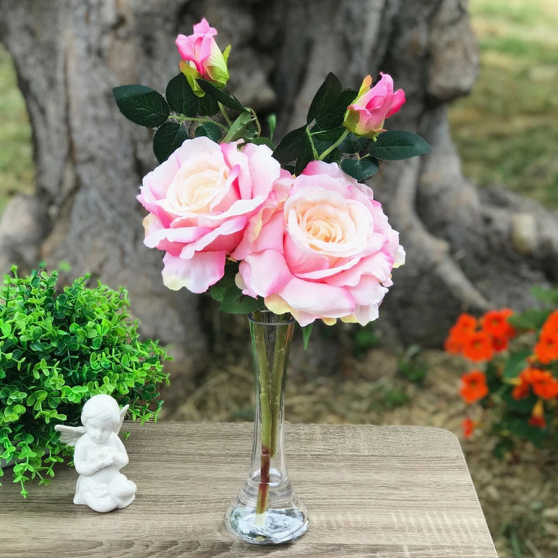 Artificial silk rose arrangement in clear glass vase with faux water, pink and white blooms