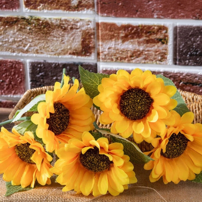 Orange faux sunflower heads with dark centers and green leaves, 5-pack for wall vase