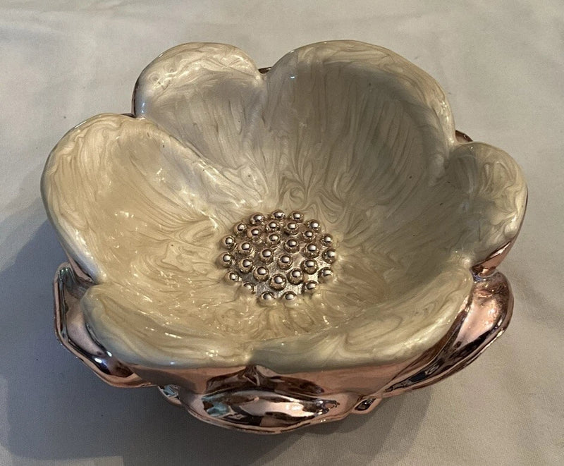 Flower-shaped rose gold trinket bowl with embossed cream petals and central jewel detail