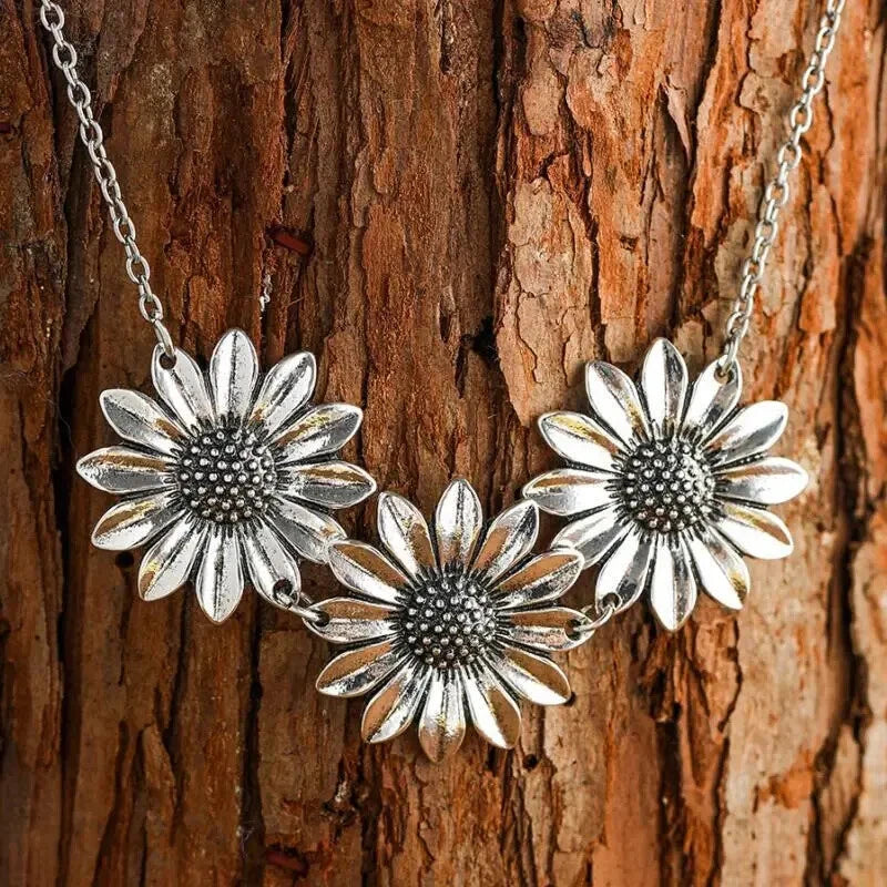 Sunflower pendant necklace with three silver-tone flower charms on a chain