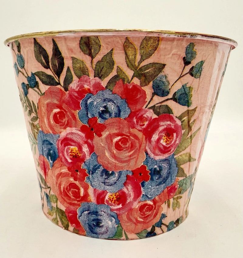 Upcycled metal flower pot with pink, red, and blue floral decoupage