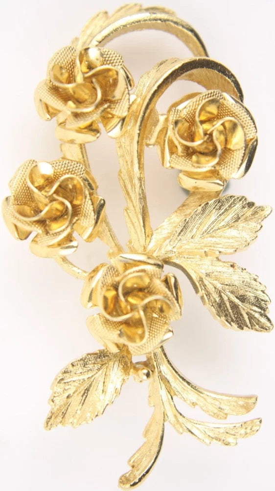 Gold-tone vintage carnation flower brooch with detailed leaves and textured petals