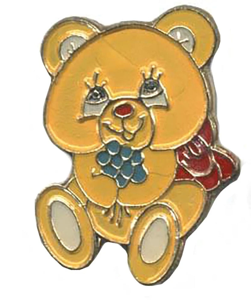 Teddy bear lapel pin with red bouquet detail and gold-tone backing