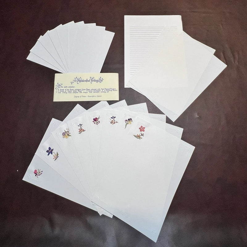 Set of white linen paper envelopes with small pressed-flower prints