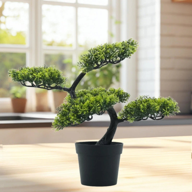 Artificial bonsai tree with layered green foliage in a black square pot