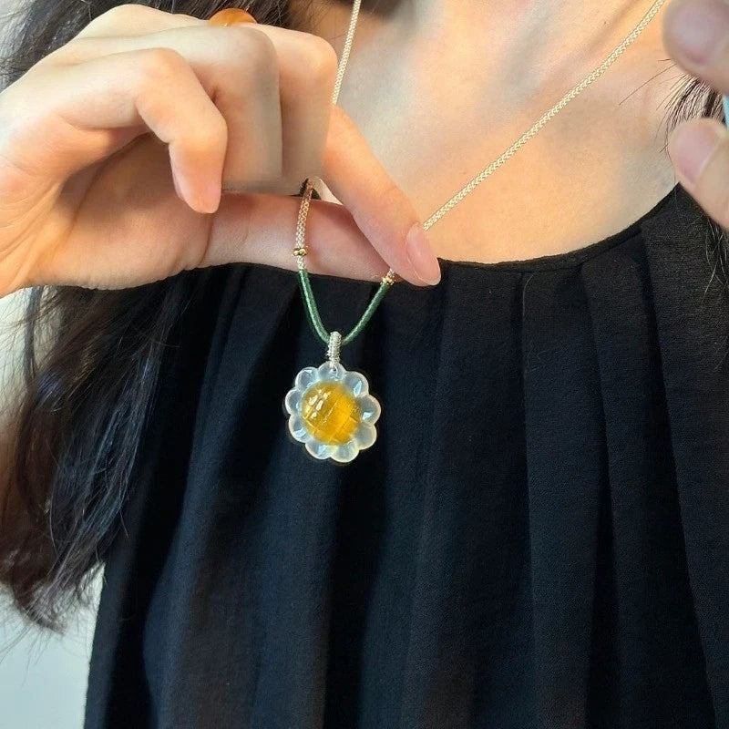 Sunflower agate pendant necklace with yellow center and white flower petals on chain