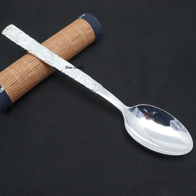 Fine silver spoon with oval bowl and textured wooden handle