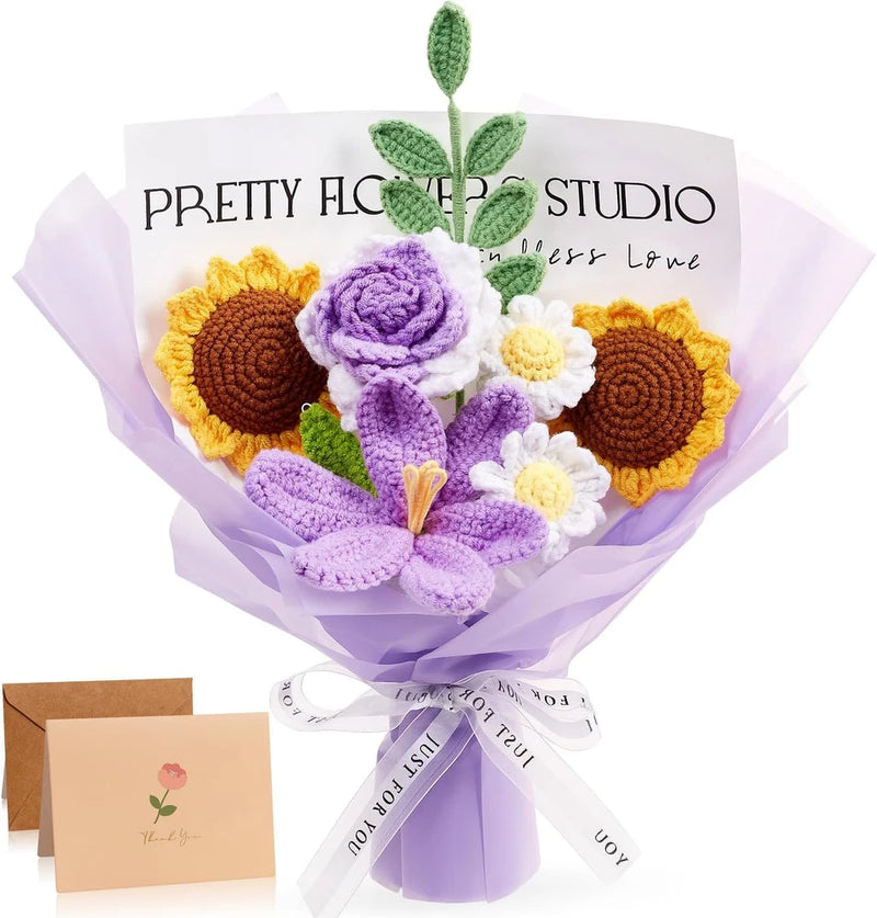 Crochet flower bouquet with purple and yellow blooms, green leaves, and tied ribbon wrap