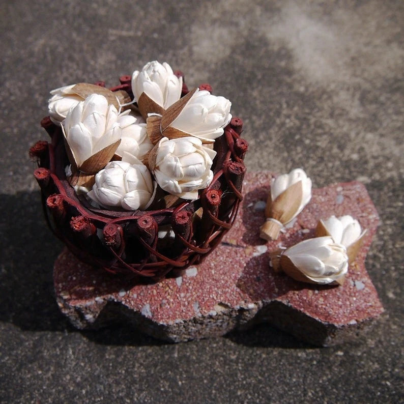 Artificial carnation diffuser flower arrangement with white blossoms and dark red wreath