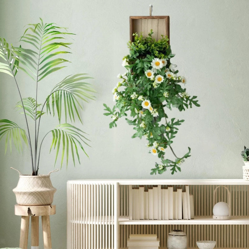 Artificial hanging flower plant with green leaves and white daisy-like blooms