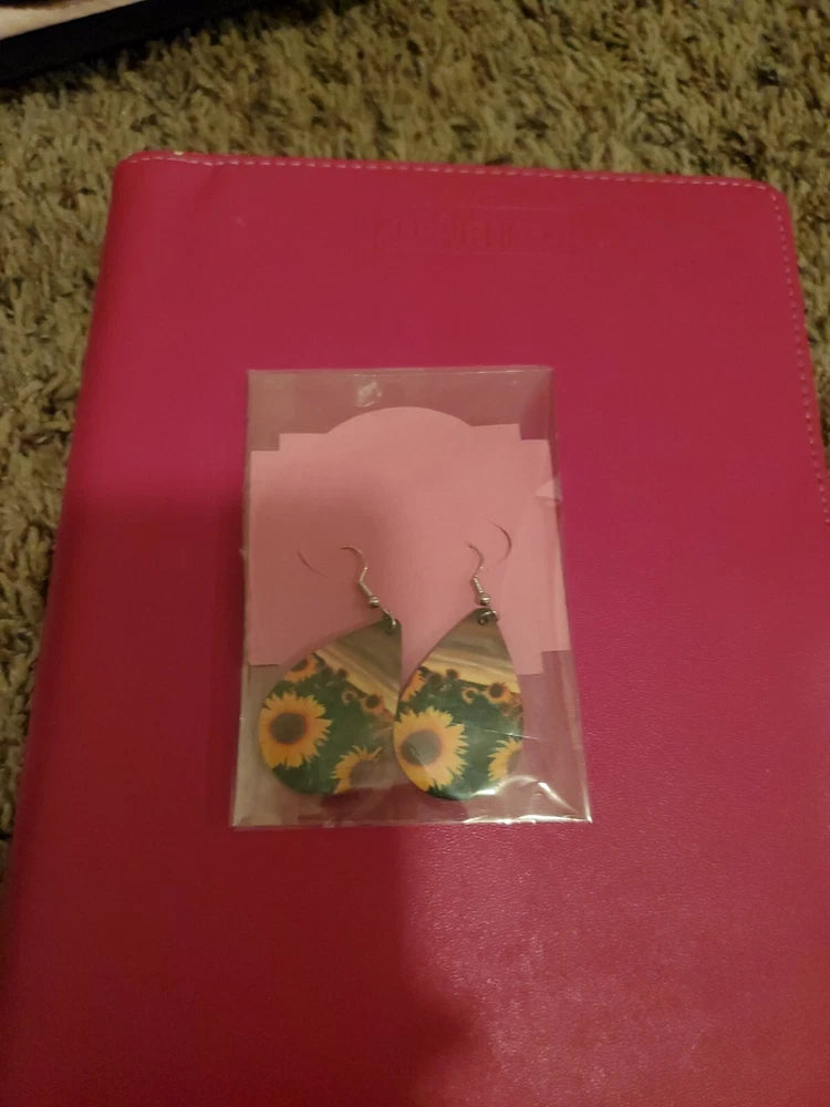 Sunflower dangle earrings, shown in a clear bag with sunflower print
