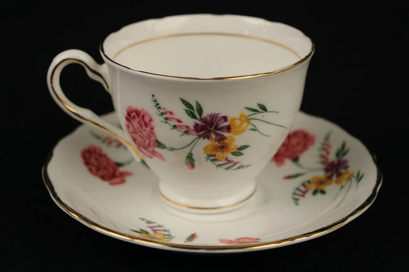 Bone china tea cup and saucer with gold trim and pink, yellow floral pattern