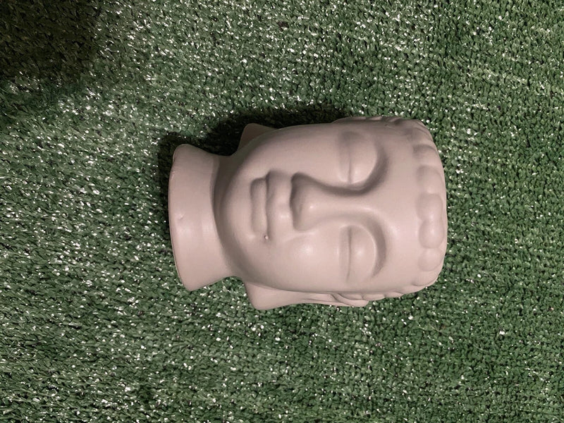 Gray ceramic Buddha head planter with serene face, small hollow for planting