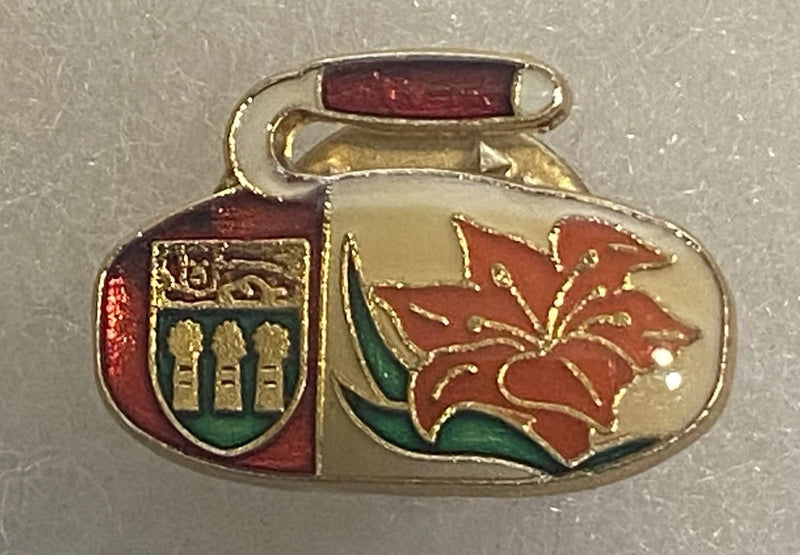 Enamel lapel pin with oval crest, gold border, burgundy and red prairie lily design