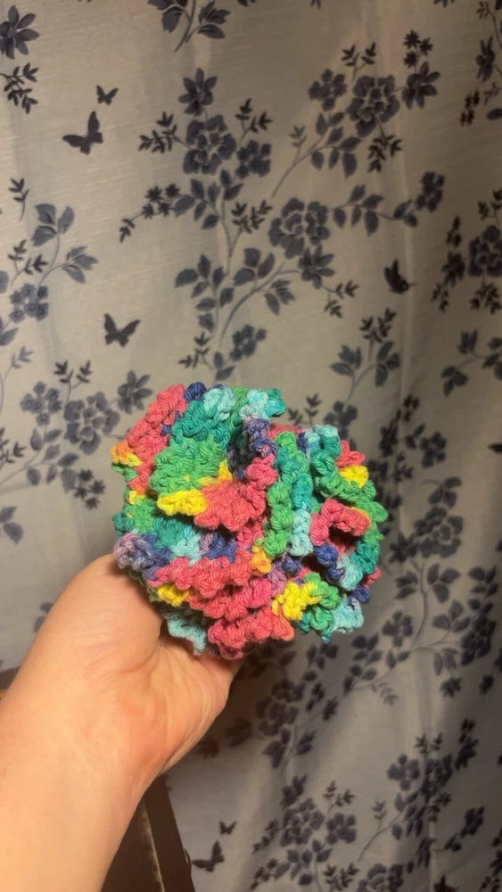 Handmade crochet carnation flower keychain charm in bright multicolor yarn