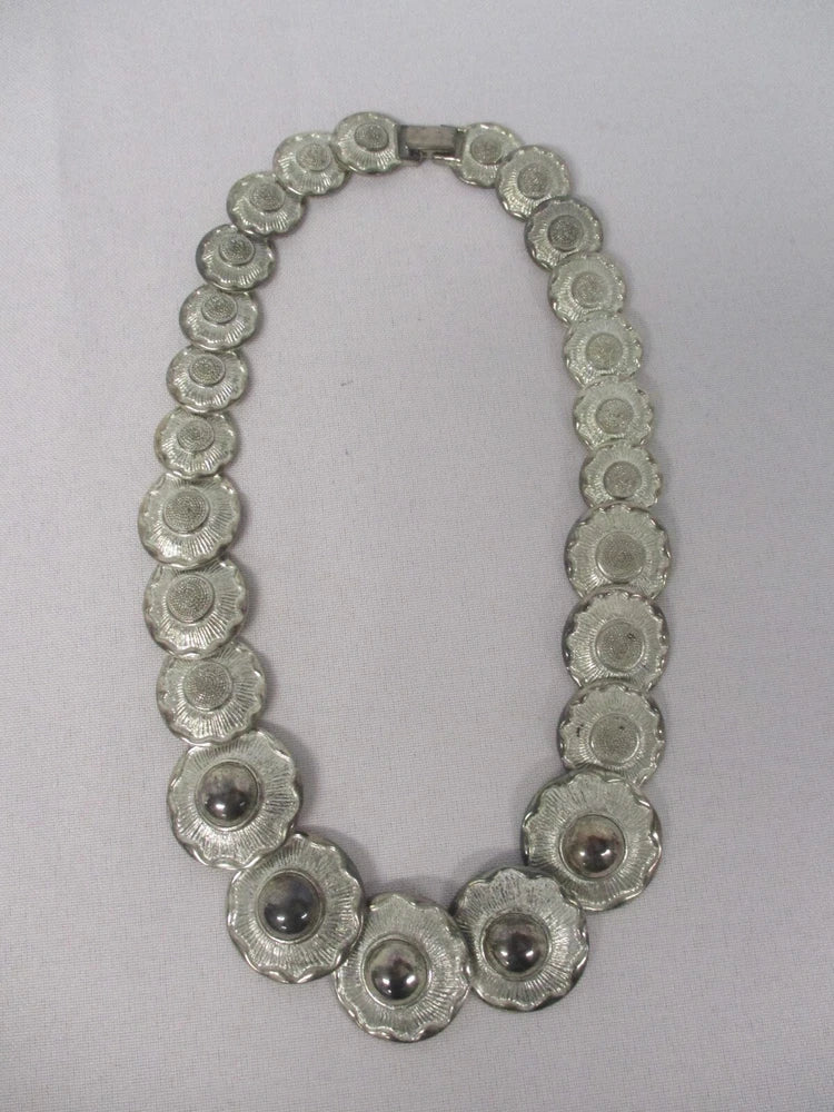 Silver-tone layered link necklace with round sunflower medallions and dark center dots