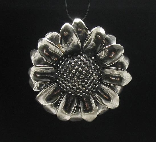 Sunflower sterling silver pendant with textured round center, petal details