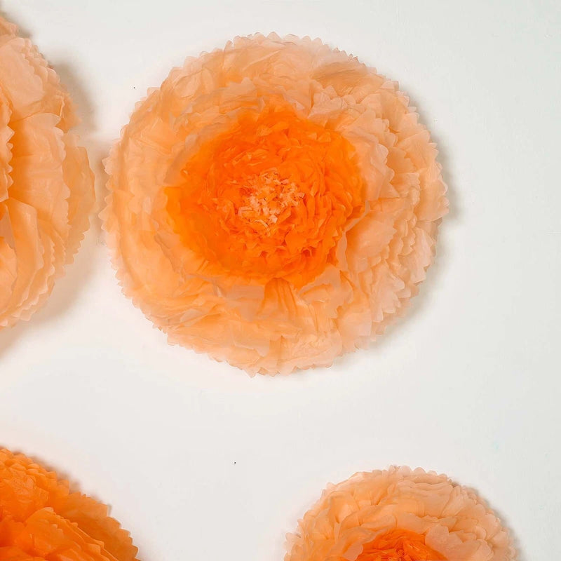 Coral and orange tissue paper carnation flower rosettes, three layered
