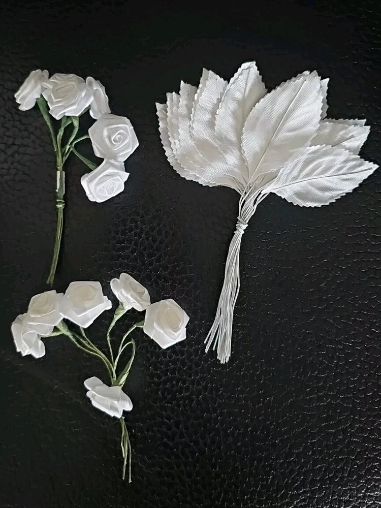 Set of white satin fabric roses with folded leaf accents and thin stems