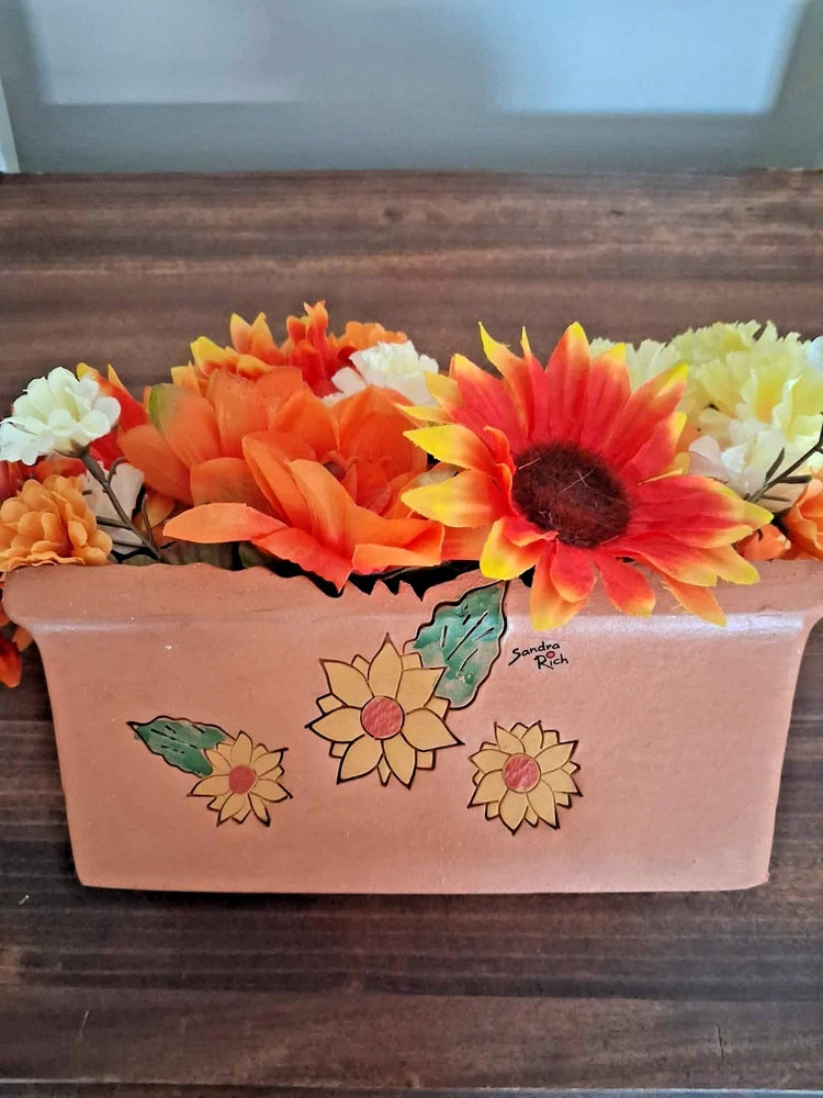 Rectangular ceramic planter with faux sunflowers, light pink floral print and Sandra Rich logo