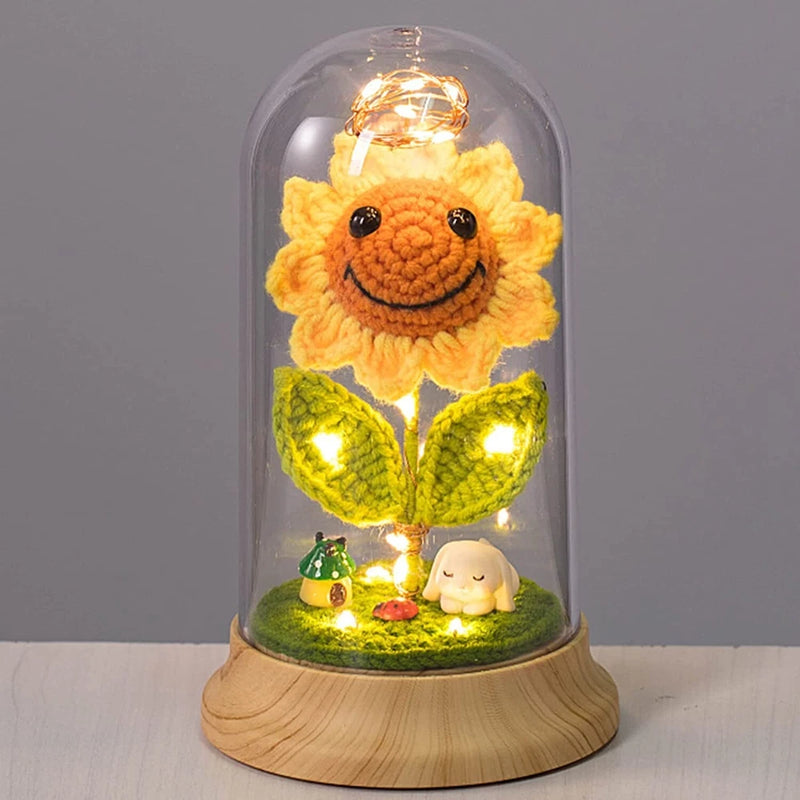 LED glass dome decor with crocheted sunflower and warm light on wooden base