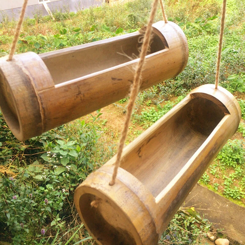 Hanging bamboo tube planter with open ends and rope loops