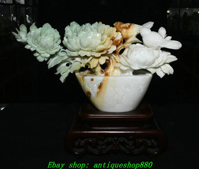 White carved jade peony bird flower pot on dark wooden stand