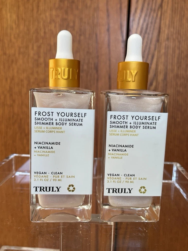 TRULY shimmer body serum bottles, clear glass with gold labels and white caps