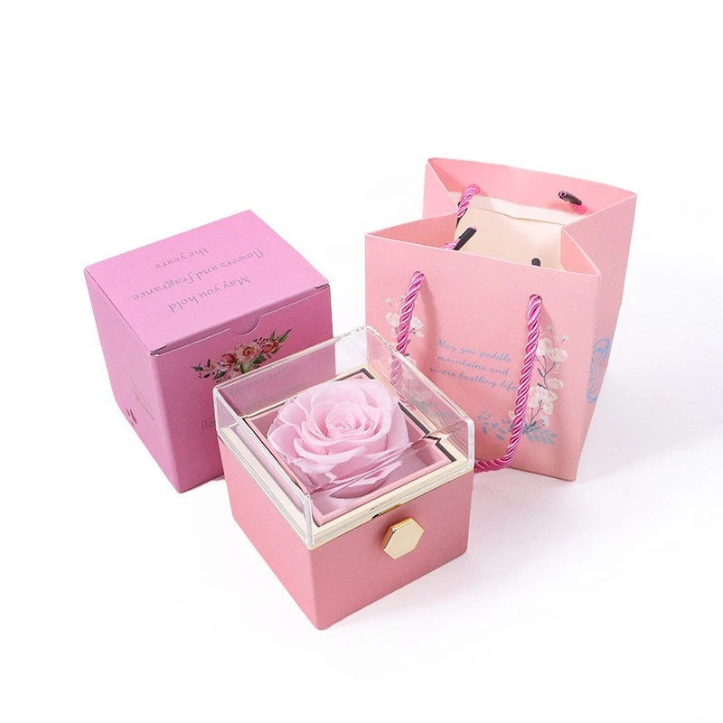 Pink rotating flower box with preserved rose in open lid