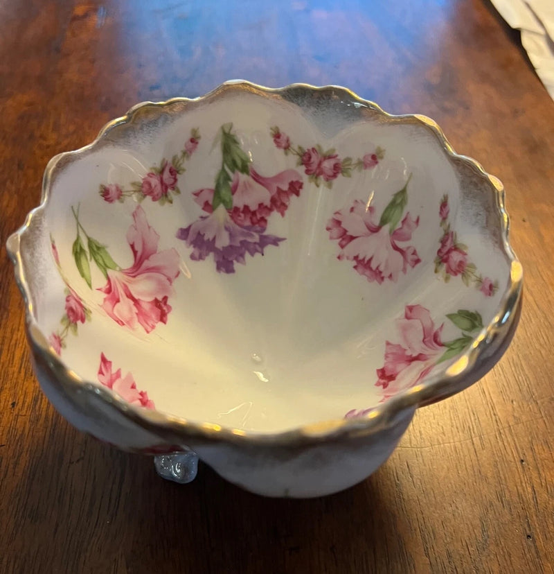 White porcelain floral footed bowl with scalloped rim and pink flower pattern, gold trim