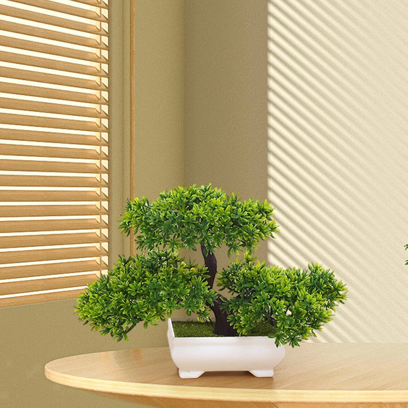 Artificial bonsai tree in white planter with green foliage