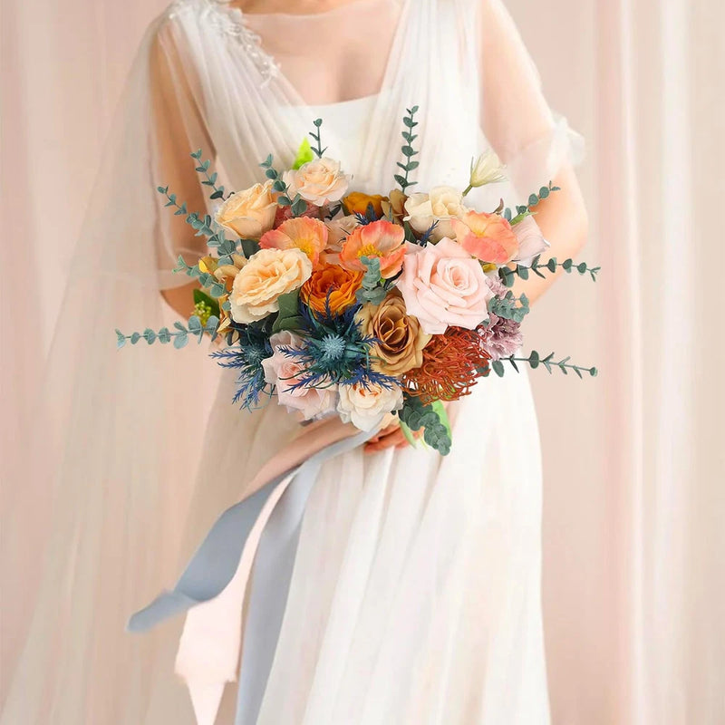 Pastel wedding memory bouquet with mixed roses, greenery, and a flowing light-blue ribbon