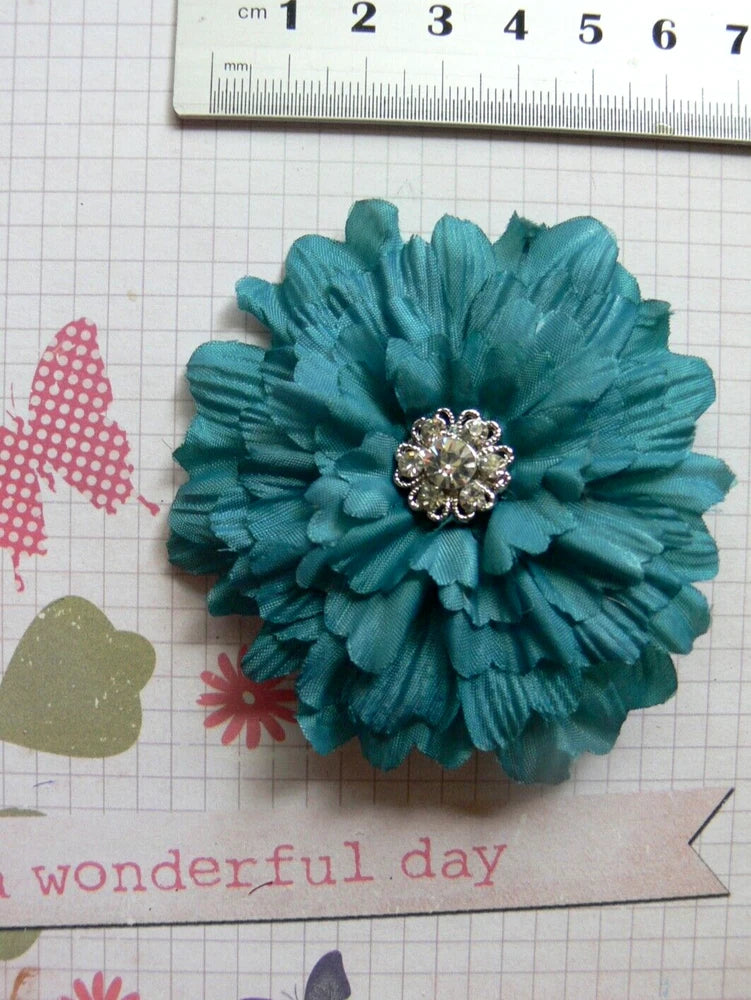 Dark teal fabric flower hair clip with jeweled silver-tone center