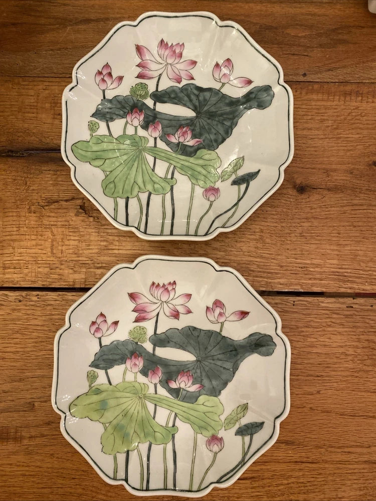 Pair of decorative water lily plates with scalloped rims and pink flower artwork