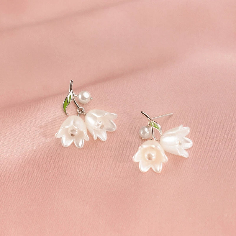Sterling silver lily flower drop earrings with white pearl center and green leaf accents